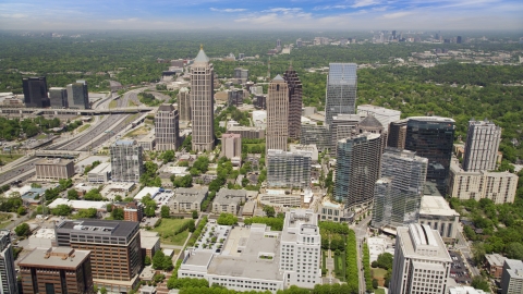 Office buildings with skyscrapers in the distance, Midtown Atlanta, Georgia Aerial Stock Photos | AX36_011.0000208F