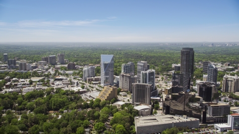 AX36_065.0000226F - Aerial stock photo of Skyscrapers and high-rises among trees, Buckhead, Georgia