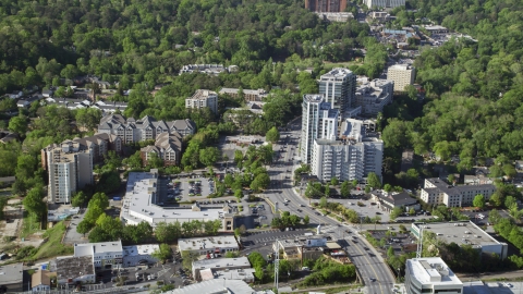 AX38_008.0000101F - Aerial stock photo of A city road past office and apartment buildings, Buckhead, Georgia