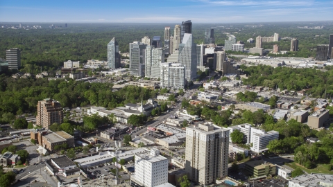 AX38_012.0000089F - Aerial stock photo of Skyscrapers overlooking forests, Buckhead, Georgia