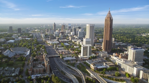 AX39_049.0000050F - Aerial stock photo of Downtown Connector along city buildings; Midtown Atlanta, Georgia, sunset