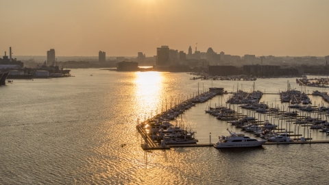 AXP073_000_0022F - Aerial stock photo of Downtown Baltimore skyline at sunset, seen from Baltimore Marine Center, Maryland