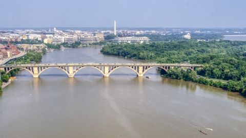 AXP075_000_0017F - Aerial stock photo of Francis Scott Key Bridge over the Potomac River, Washington Monument in background in Washington DC