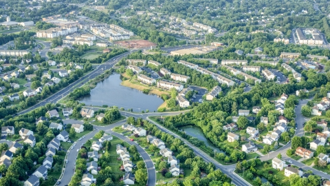 AXP075_000_0027F - Aerial stock photo of Waterfront row houses and homes by a small pond in Manassas, Virginia