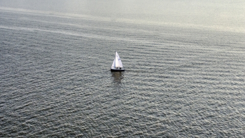 AXP076_000_0004F - Aerial stock photo of A sailboat on the Potomac River, Washington, D.C., sunset