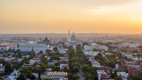 AXP076_000_0015F - Aerial stock photo of Library of Congress, United States Capitol, Washington Monument, Supreme Court, Washington D.C., sunset