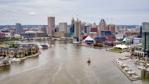 AXP078_000_0010F - Aerial stock photo of Downtown Baltimore skyscrapers, Inner Harbor piers, and the National Aquarium, Maryland