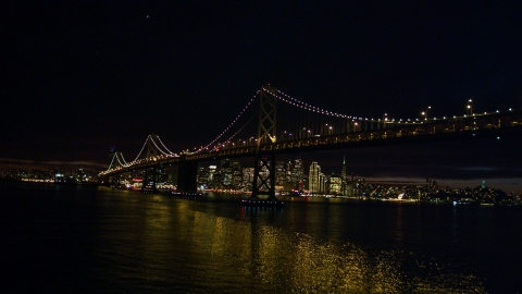 DCSF06_002.0000085 - Aerial stock photo of The Bay Bridge in front of the Downtown San Francisco skyline, California, night