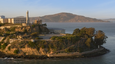 DCSF07_033.0000000 - Aerial stock photo of Alcatraz lighthouse and part of the island in San Francisco, California, sunset