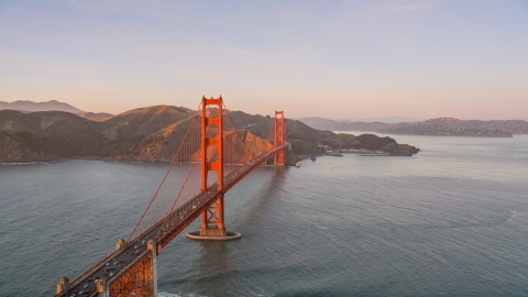 DCSF07_052.0000301 - Aerial stock photo of Golden Gate Bridge, Marin Headlands in the background, San Francisco, California, sunset