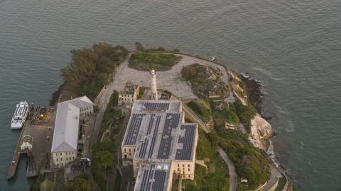 DCSF10_024.0000245 - Aerial stock photo of The Alcatraz lighthouse and main building, San Francisco, California, sunset