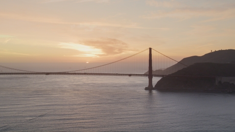 DCSF10_026.0000139 - Aerial stock photo of Golden Gate Bridge with setting sun in the distance, San Francisco, California, sunset