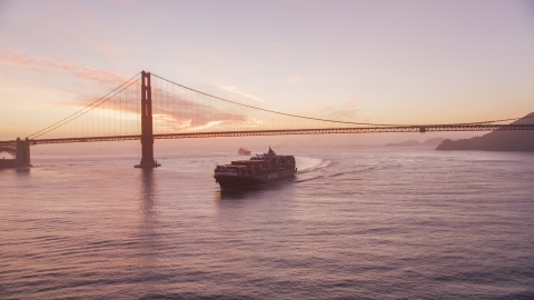 A cargo ship sailing by the Golden Gate Bridge, San Francisco, California, twilight Aerial Stock Photos | DCSF10_041.0000043