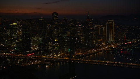 DCSF10_071.0000539 - Aerial stock photo of Heavy traffic on the Bay Bridge by Downtown San Francisco skyscrapers, California, night