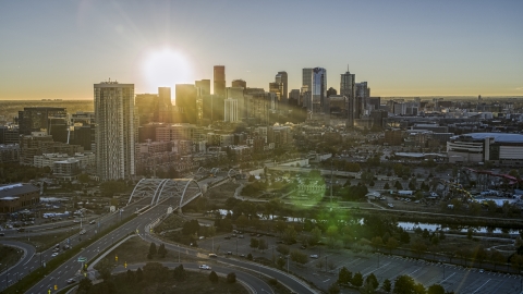 DXP001_000101 - Aerial stock photo of The city skyline with the bright sun above the skyscrapers at sunrise in Downtown Denver, Colorado