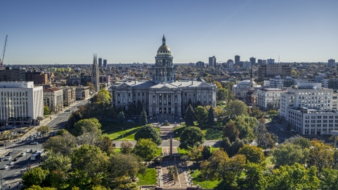 DXP001_000140 - Aerial stock photo of Colorado State Capitol building seen from the trees at Civic Center Park in Downtown Denver, Colorado