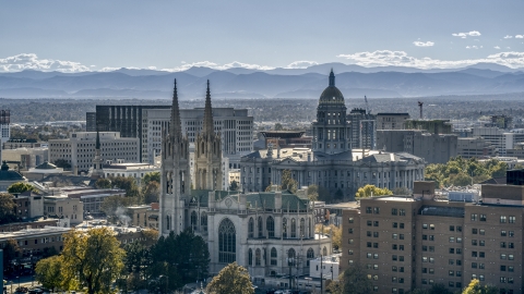 DXP001_000164 - Aerial stock photo of The Colorado State Capitol behind a cathedral, Downtown Denver, Colorado