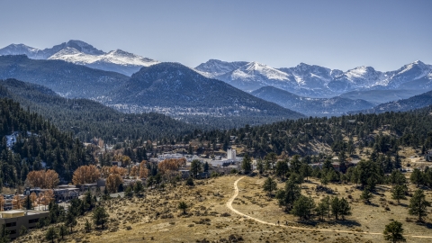 DXP001_000214 - Aerial stock photo of A small town and giant, snowy mountains in Estes Park, Colorado