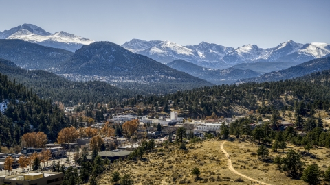 DXP001_000217 - Aerial stock photo of A small town with snowy mountains visible in the distance in Estes Park, Colorado