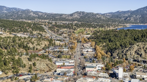 DXP001_000226 - Aerial stock photo of Shops on a road through town, with mountains and Lake Estes in the background, Estes Park, Colorado