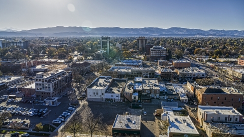 Shops with taller office buildings and mountains in the background in Fort Collins, Colorado Aerial Stock Photos | DXP001_000234