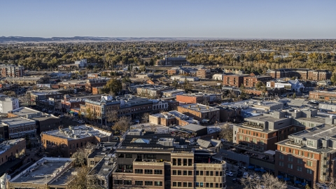 A view across the tops of brick office buildings and small shops in Fort Collins, Colorado Aerial Stock Photos | DXP001_000247