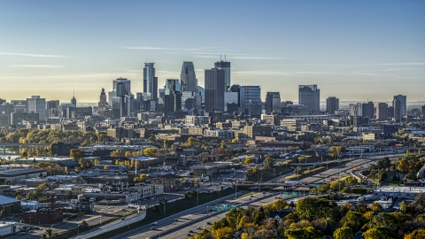 DXP001_000277 - Aerial stock photo of A view of the city skyline's skyscrapers at sunrise seen from trees in Downtown Minneapolis, Minnesota