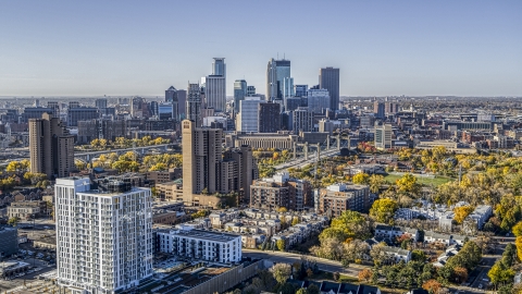 DXP001_000285 - Aerial stock photo of Condo complex in the foreground, city skyline's skyscrapers in the background at sunrise, Downtown Minneapolis, Minnesota