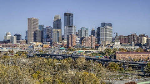 DXP001_000312 - Aerial stock photo of The city's skyline behind the I-394 freeway, seen from a cluster of trees, Downtown Minneapolis, Minnesota