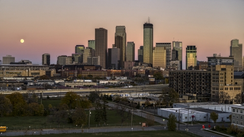 DXP001_000328 - Aerial stock photo of The moon in the sky beside the city's skyline at twilight in Downtown Minneapolis, Minnesota