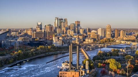 DXP001_000356 - Aerial stock photo of The city's skyline seen from power plant by the Mississippi River at sunrise, Downtown Minneapolis, Minnesota