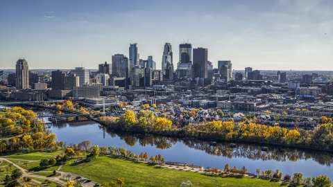 DXP001_000403 - Aerial stock photo of A view across the Mississippi River with fall trees at the city's skyline, Downtown Minneapolis, Minnesota