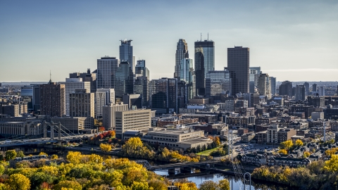 DXP001_000406 - Aerial stock photo of A view over autumn trees by the Mississippi River of the city's skyline, Downtown Minneapolis, Minnesota