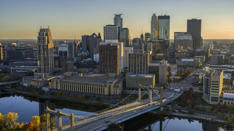 DXP001_000414 - Aerial stock photo of Skyline seen from the Hennepin Avenue Bridge spanning the river at sunset, Downtown Minneapolis, Minnesota