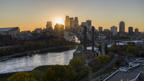 DXP001_000421 - Aerial stock photo of The skyline across the Mississippi River, seen from a power plant at sunset, Downtown Minneapolis, Minnesota