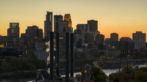 DXP001_000437 - Aerial stock photo of The downtown skyline at twilight, seen from smoke stacks near the river, Downtown Minneapolis, Minnesota