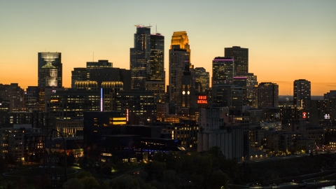 DXP001_000445 - Aerial stock photo of The skyscrapers in the downtown skyline lit up for the night at twilight, Downtown Minneapolis, Minnesota