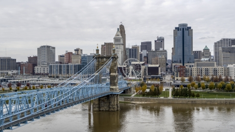 DXP001_000472 - Aerial stock photo of The side of the Roebling Bridge with the Ferris wheel and skyline in the distance, Downtown Cincinnati, Ohio