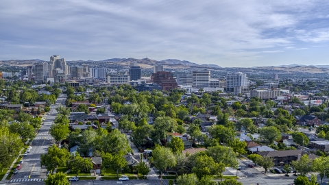 Casino resorts and office buildings seen from neighborhood with trees in Reno, Nevada Aerial Stock Photos | DXP001_006_0015