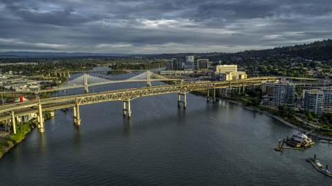 DXP001_014_0002 - Aerial stock photo of The Marquam and Tilikum Crossing bridges spanning the Willamette River at sunset in South Portland, Oregon