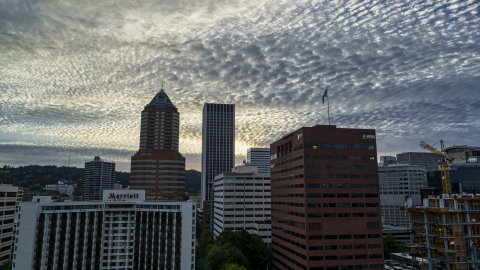 DXP001_014_0006 - Aerial stock photo of Tall skyscrapers behind hotel and office building at sunset in Downtown Portland, Oregon