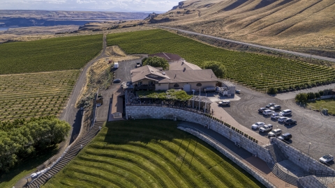 DXP001_018_0023 - Aerial stock photo of Maryhill Winery and grapevines seen from the amphitheater in Goldendale, Washington