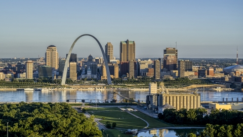 DXP001_021_0006 - Aerial stock photo of A grain elevator and park with a view of the Arch and skyline across the Mississippi River, sunrise, Downtown St. Louis, Missouri