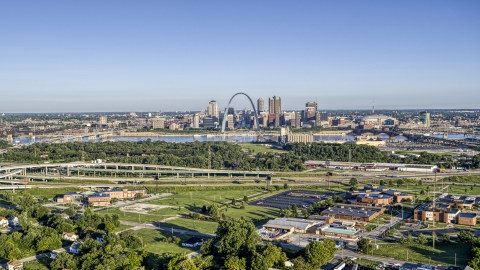 DXP001_022_0006 - Aerial stock photo of School and interstate in East St. Lous with view of skyline and Arch in Downtown St. Louis, Missouri