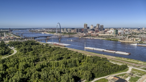 DXP001_023_0004 - Aerial stock photo of Barges on the river and the Gateway Arch, Downtown St. Louis, Missouri