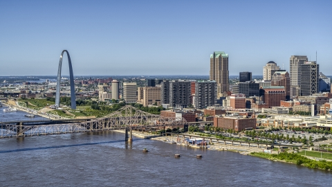 DXP001_024_0002 - Aerial stock photo of A view of riverfront office buildings near a bridge with Arch in the background, Downtown St. Louis, Missouri