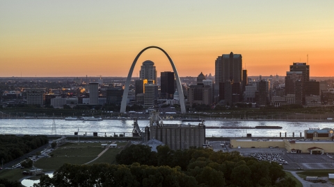 A view across the river of the Gateway Arch and Downtown St. Louis skyline, Missouri at sunset Aerial Stock Photos | DXP001_029_0003