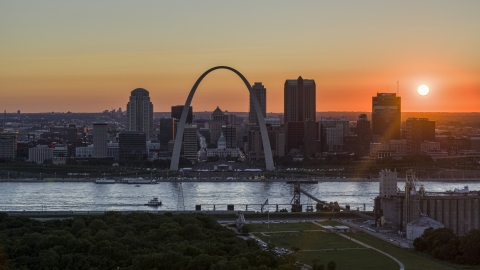 The setting sun behind the Gateway Arch and Downtown St. Louis, Missouri Aerial Stock Photos | DXP001_029_0005