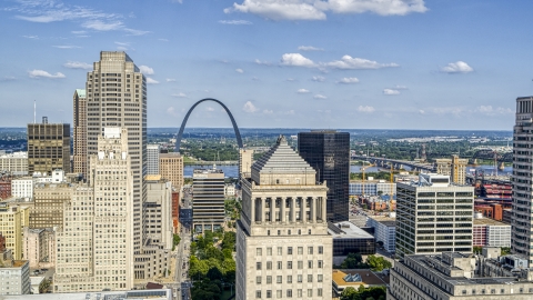 DXP001_031_0007 - Aerial stock photo of The Gateway Arch seen between skyscrapers and a courthouse tower in Downtown St. Louis, Missouri