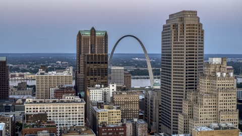 DXP001_036_0010 - Aerial stock photo of The Gateway Arch visible between two tall skyscrapers at twilight, Downtown St. Louis, Missouri